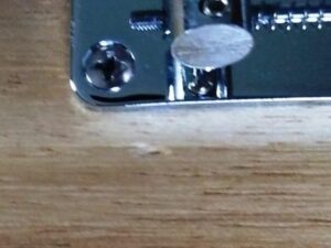 Small blemish next to the bridge assembly.