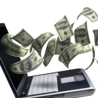 Laptop computer with money coming out of the screen