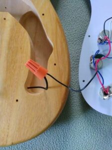 Connecting the ground wires using a wire nut.
